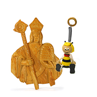 A wood carving of Saint Ambrose and a spring-loaded bee side by side