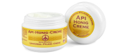 Api-Honig-Creme, Frontansicht, ein Tiegel offen, Deckel stehend daneben