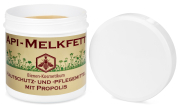 Api-Melkfett, Frontansicht, eine Dose offen, Deckel stehend daneben